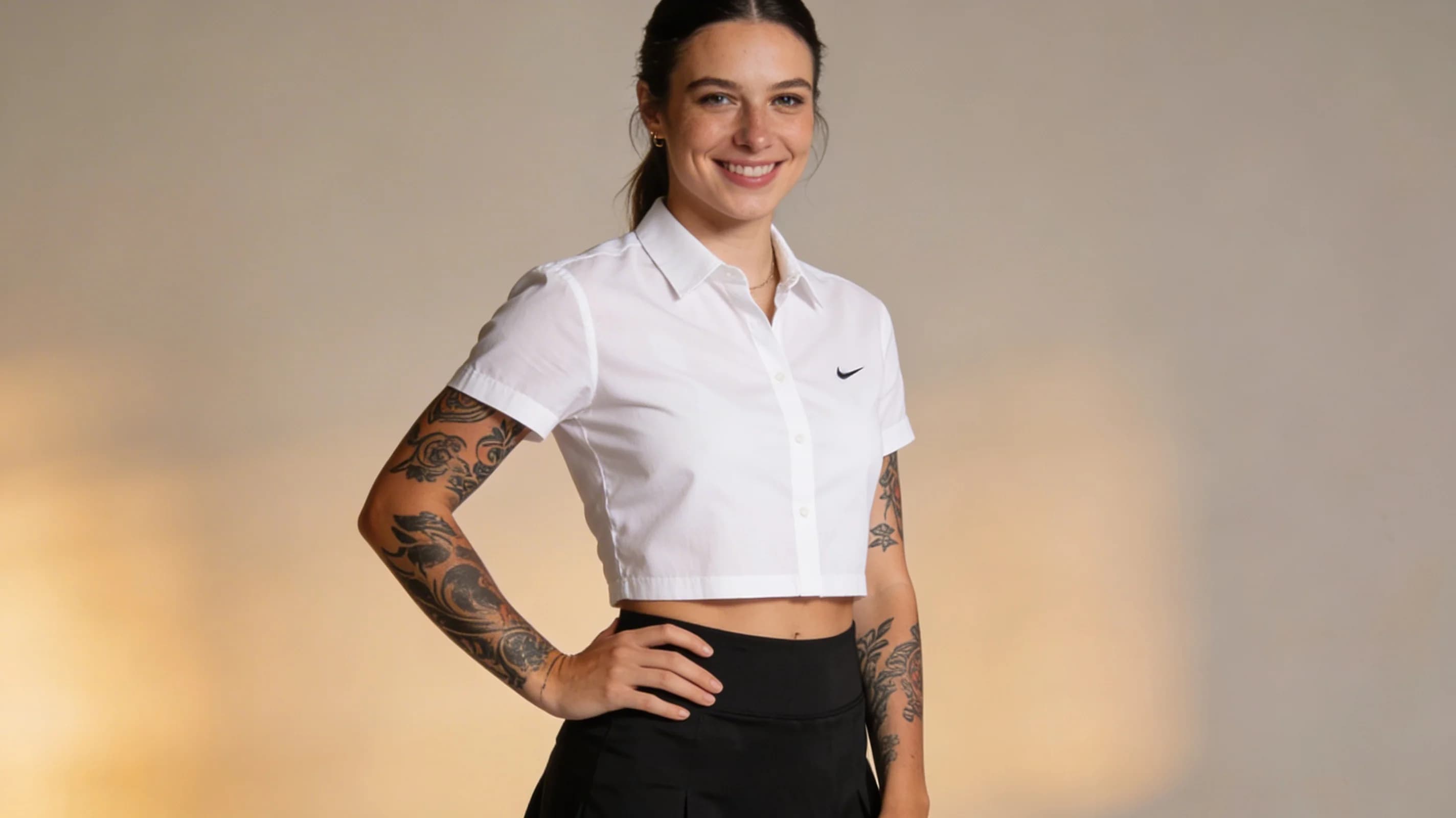Wearing short black tennis skirt and a crop top shirt, portrait picture, looking at the viewer with a smile, wearing a fashionable mini skirt, kneeling pose, elegant position, tanning on a beach lounger, with artistic tattoos, wearing a fashionable choker, in a cozy bedroom setting, wearing a stylish bikini on the beach, wearing a stylish fitted jumpsuit, stretching gracefully, squatting position, athletic pose